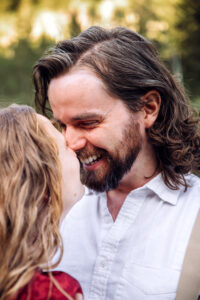 Man touching woman's nose with his own and laughing, captured by Utah engagement photographer.