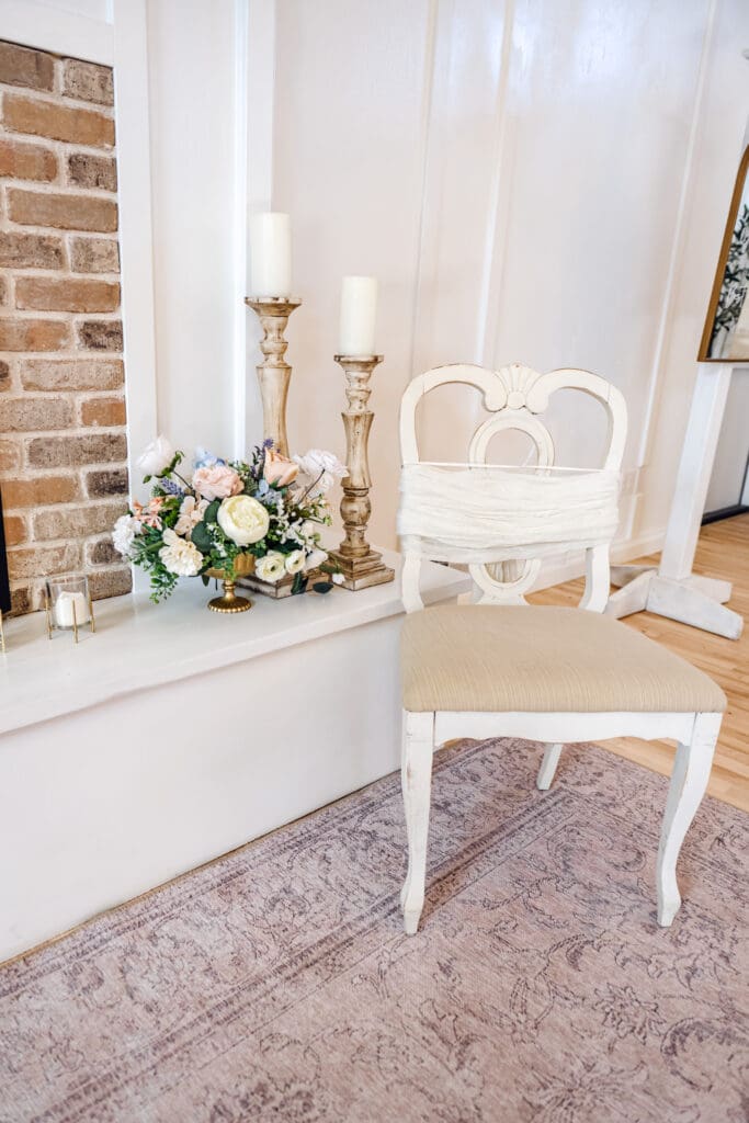 The Aisle in Sugar City, a wedding venue, with light coming through windows and set up for recpetions with dark wood tables, florals, and light linens, captured by Rexburg wedding photographer. 